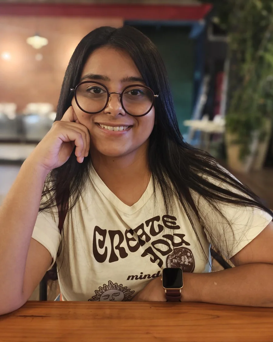 Gunjari Bhattacharya, smiling, in round glasses